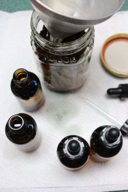 Putting cinnamon oil into bottles.