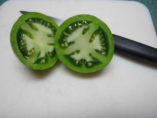 Cut the tomato in half.