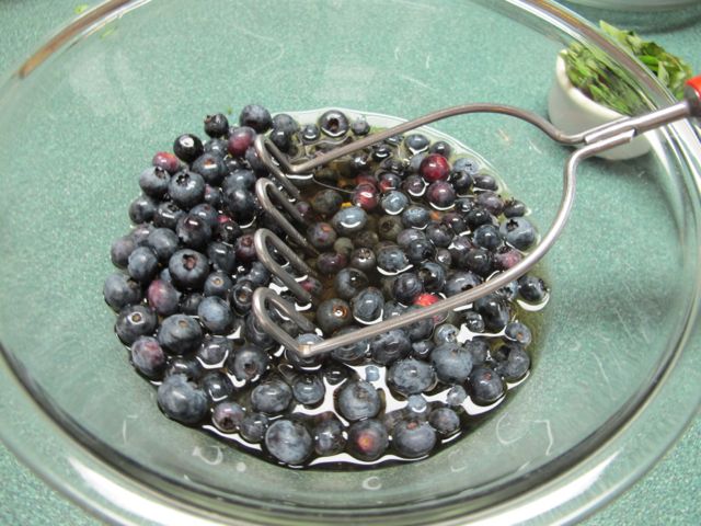 Lightly crush the blueberries.