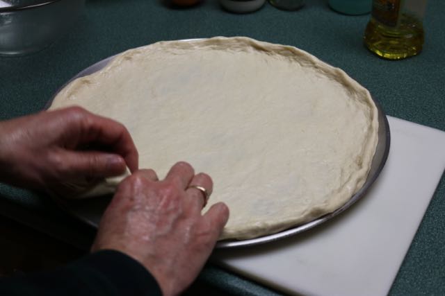 Form pizza dough.
