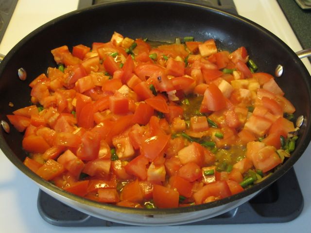 Cook tomatoes until soft.