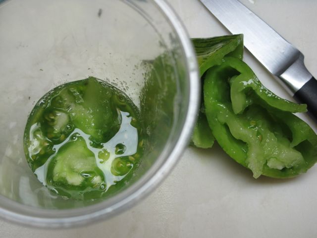 Squeeze the tomato into a cup.