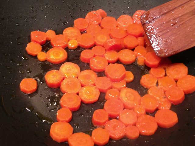 Saute carrots in a large pan.