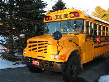 Front of a yellow school bus. Front of a yellow school bus.
