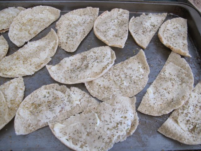 Cut pitas in half and spread with butter or olive oil.