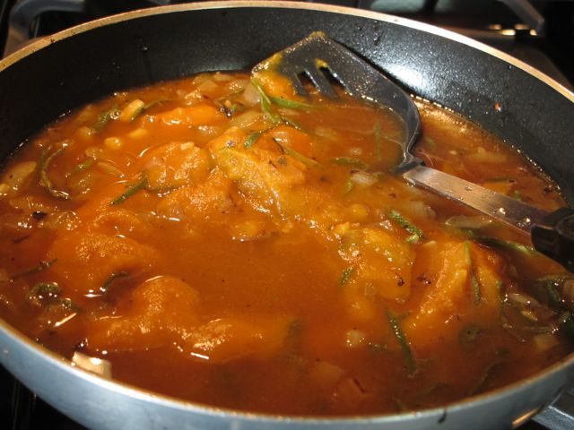 Add chicken stock and pumpkin.