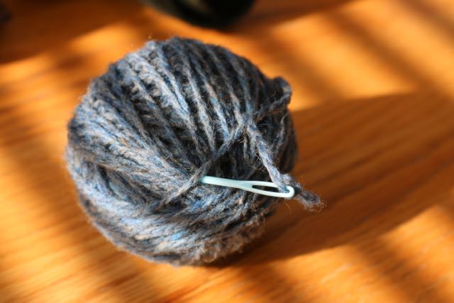 Use a needle to tuck in the loose end or yarn.