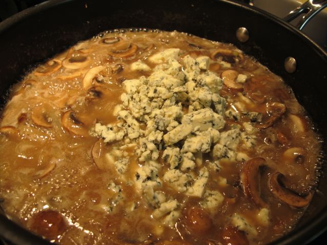 Stirring in the blue cheese.