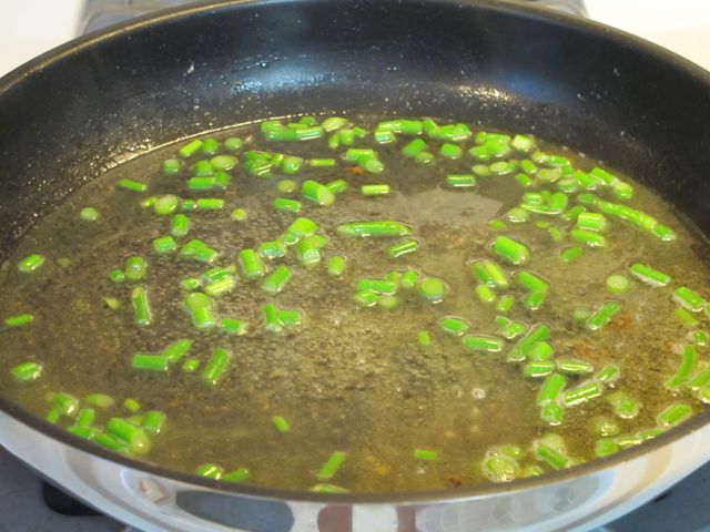 Simmer the scapes in the wine.