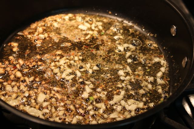 Saute garlic, oregano and pepper flakes.
