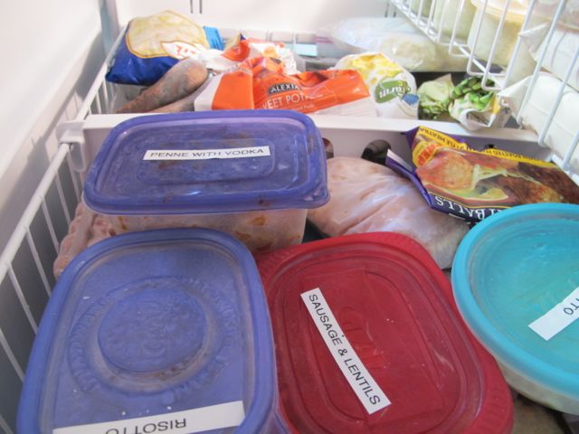 Labeled containers of leftovers in the freezer.