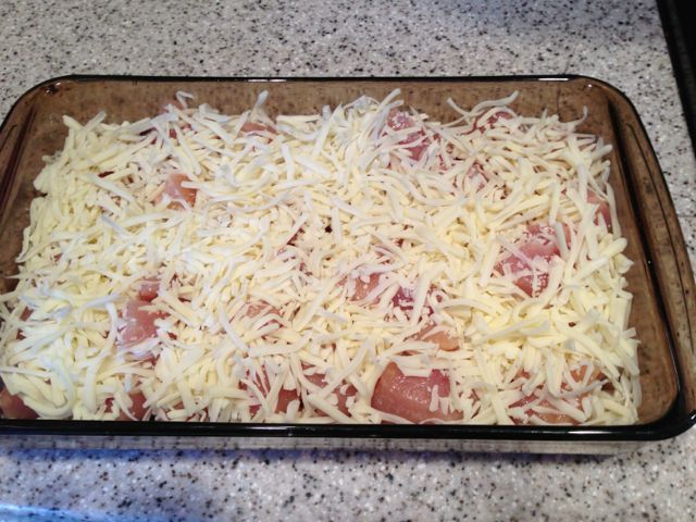 Spread the cheese over the chicken.