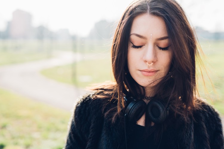 Half length of young beautiful caucasian woman with headphones
